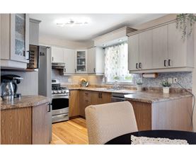 A kitchen with wooden cabinets and a granite countertop.