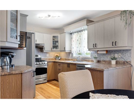 A kitchen with wooden cabinets and a granite countertop.