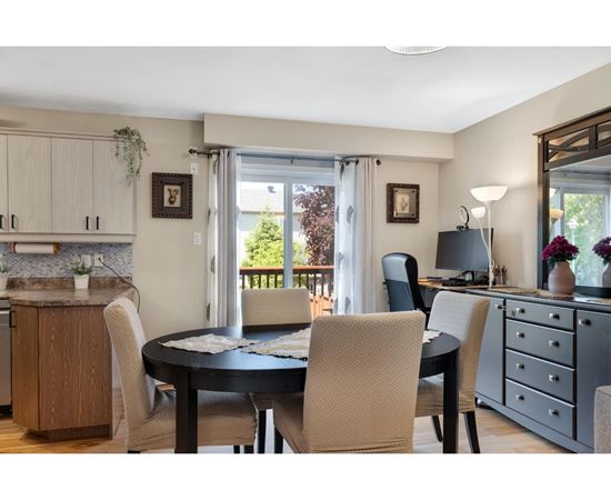 A dining room with a table set for four.