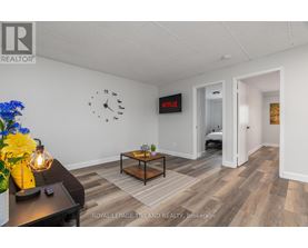 A room with a clock on the wall and a Netflix sign.