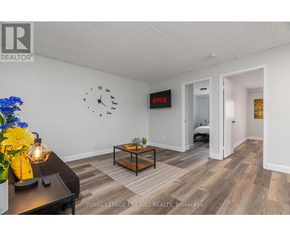 A room with a clock on the wall and a Netflix sign.