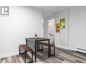 A dining room with a table and chairs.