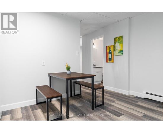 A dining room with a table and chairs.