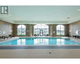 A large indoor swimming pool with a view of the outside.