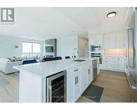 A modern kitchen with white cabinets and a large island.