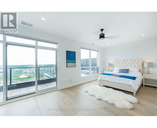 A bedroom with a large bed and a view of the outside.