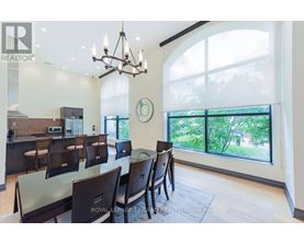 A dining room with a glass table and chairs.