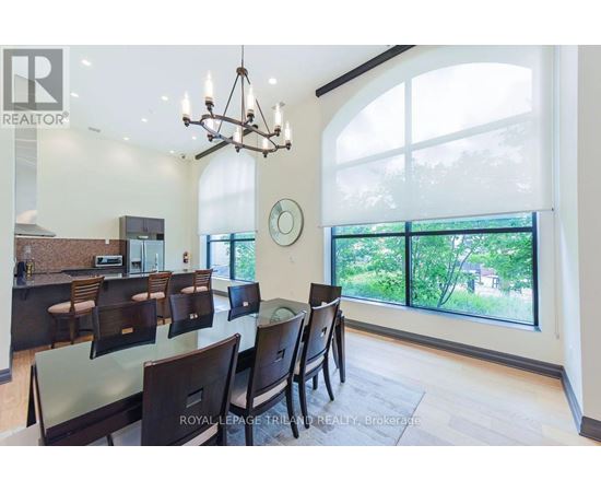 A dining room with a glass table and chairs.
