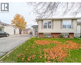 A house with a lawn full of fallen leaves in front of it.