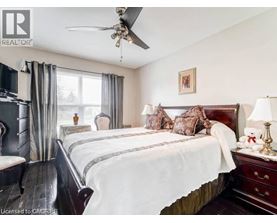 A bedroom with a large bed and a ceiling fan.
