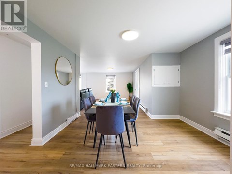 A dining room with a table set for four.