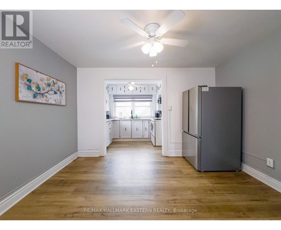 A spacious kitchen with a refrigerator on the right side.