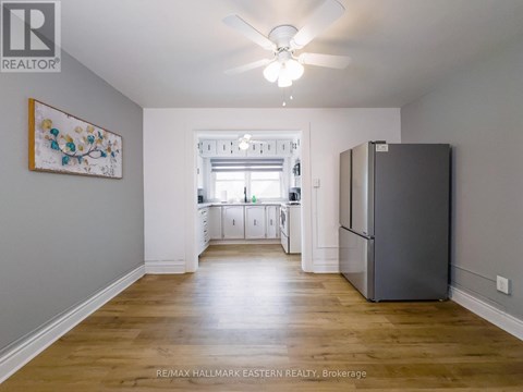 A spacious kitchen with a refrigerator on the right side.