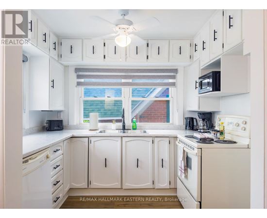 A white kitchen with a window and a sink.