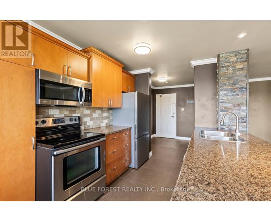 A kitchen with wooden cabinets and a granite countertop.