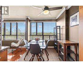 A dining room with a table and chairs and a ceiling fan.