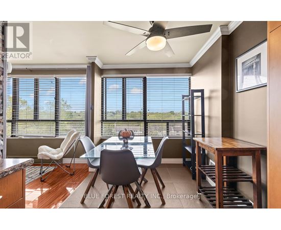 A dining room with a table and chairs and a ceiling fan.