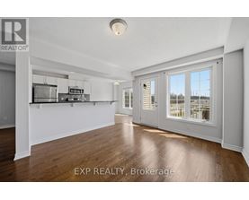 A spacious room with wooden flooring and white walls.