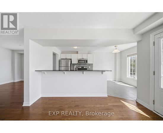 A white kitchen with a white counter and white cabinets.