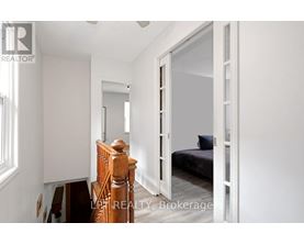 A bedroom with a bed, dresser, and mirror.