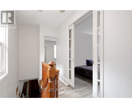 A bedroom with a bed, dresser, and mirror.