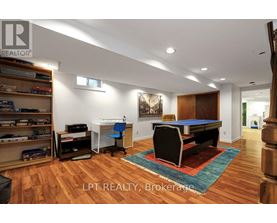 A room with a pool table and a bookshelf.
