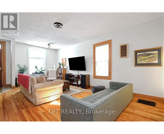 A living room with a grey couch and a television.