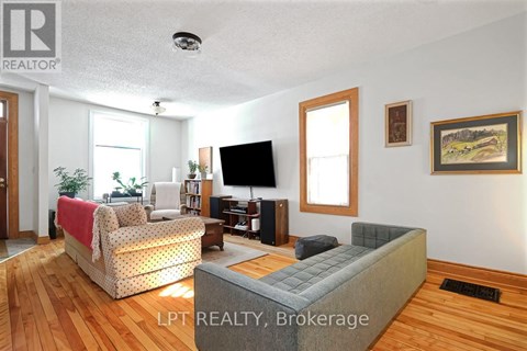 A living room with a grey couch and a television.