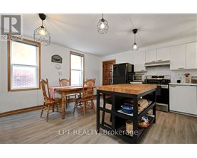 A kitchen with a table and chairs in the middle of the room.
