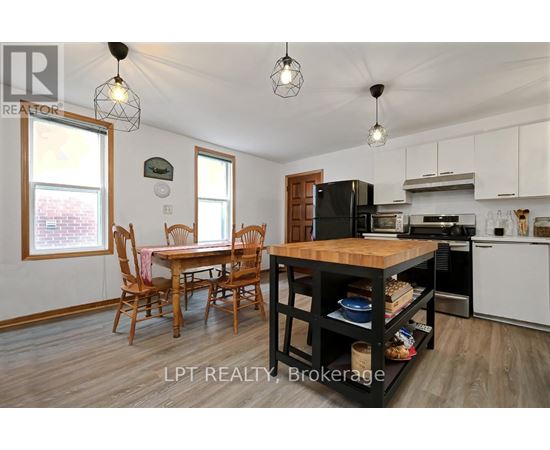 A kitchen with a table and chairs in the middle of the room.