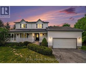 A house with a white exterior and a black roof is shown with the text "Enas Award, Brokerage" in the foreground.
