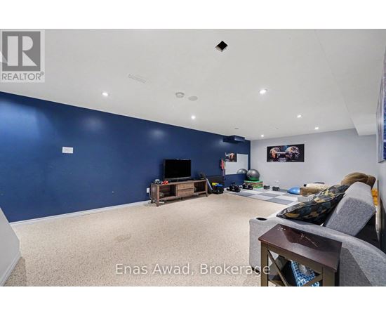 A living room with a grey couch and a television.