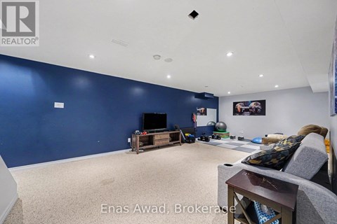 A living room with a grey couch and a television.