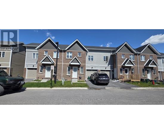 A row of houses with a car parked in front of the first house.