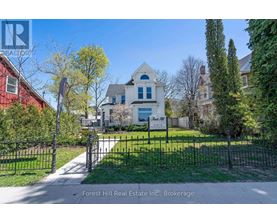 A house with a sign that says Forest Hill Real Estate Inc., Brokerage.