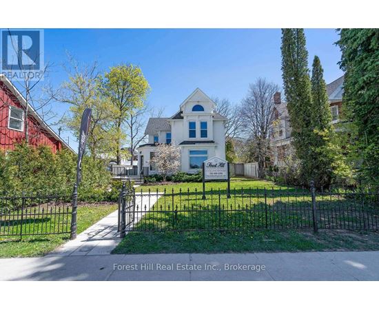 A house with a sign that says Forest Hill Real Estate Inc., Brokerage.