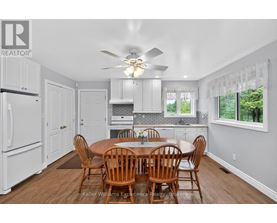 A dining room with a table and chairs.