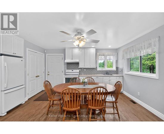 A dining room with a table and chairs.