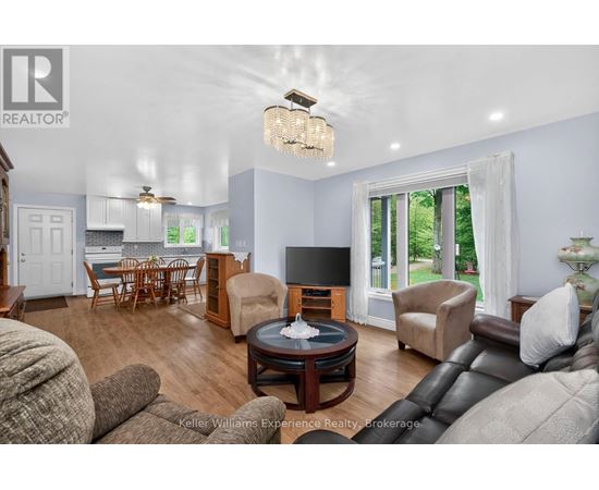 A living room with a brown leather couch and a wooden coffee table.