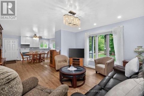 A living room with a brown leather couch and a wooden coffee table.