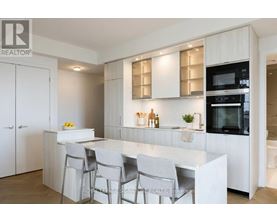 A modern kitchen with white cabinets and a central island.