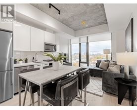A modern kitchen with a dining table and chairs.