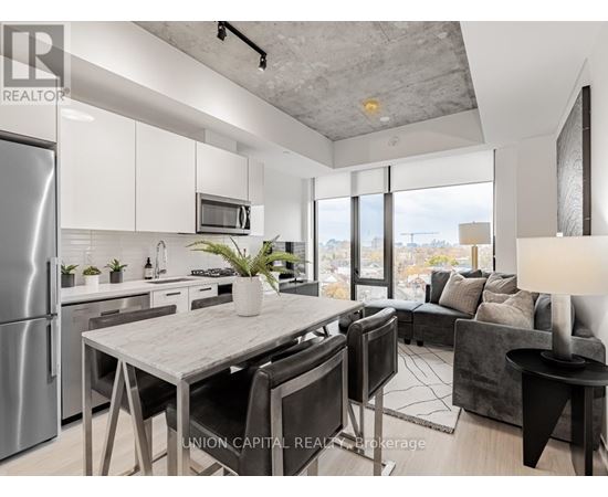 A modern kitchen with a dining table and chairs.