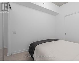 A bedroom with a bed and a door.