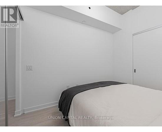 A bedroom with a bed and a door.