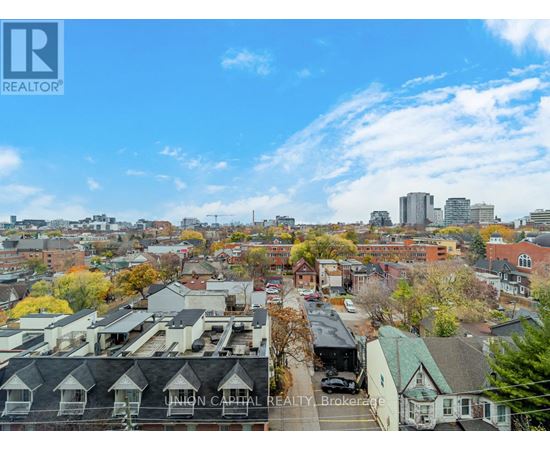 A view of a city from a high vantage point with buildings and trees.