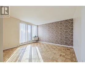 A room with a brick wall and a tiled floor.
