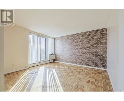 A room with a brick wall and a tiled floor.