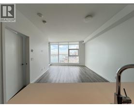 A realtor's office with a large table and a view of the city through the window.