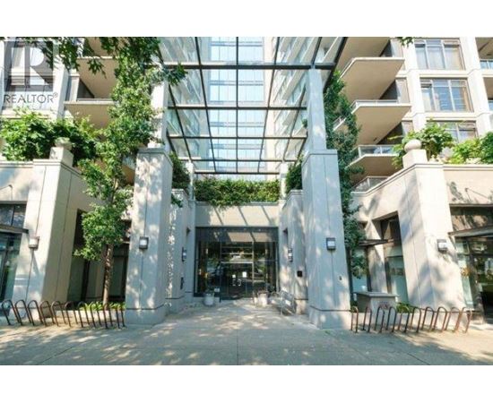 A glass ceiling with plants hanging from it and a building with a sign that says REALTOR.